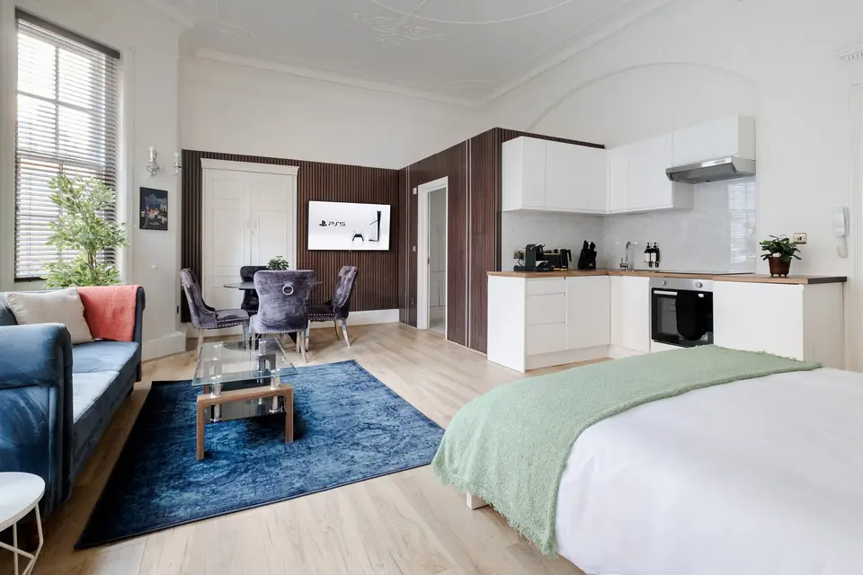 Studio with a king bed and dining table