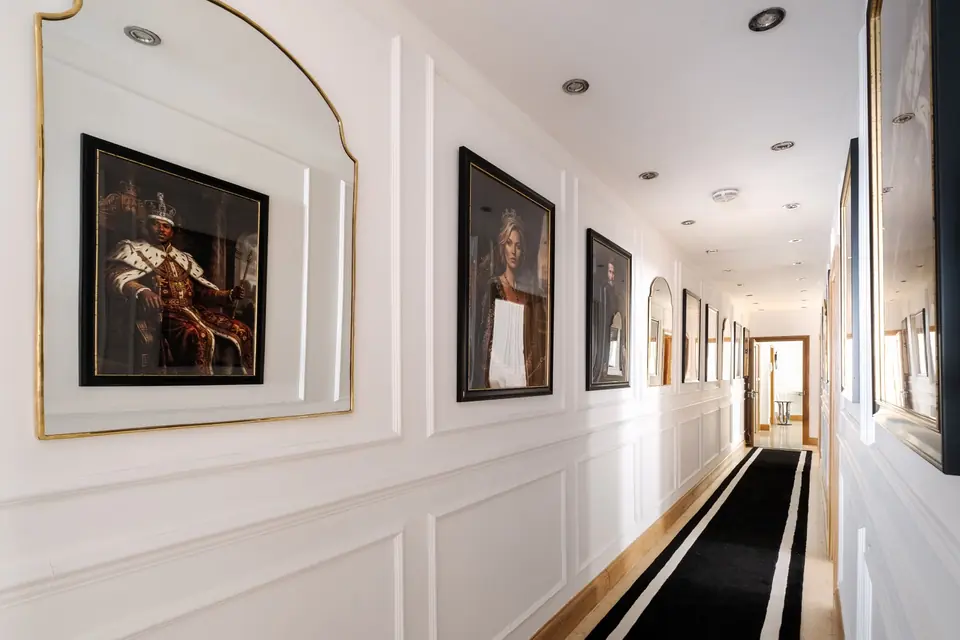 Gallery corridor hung with portraits at The Jewel of Mayfair