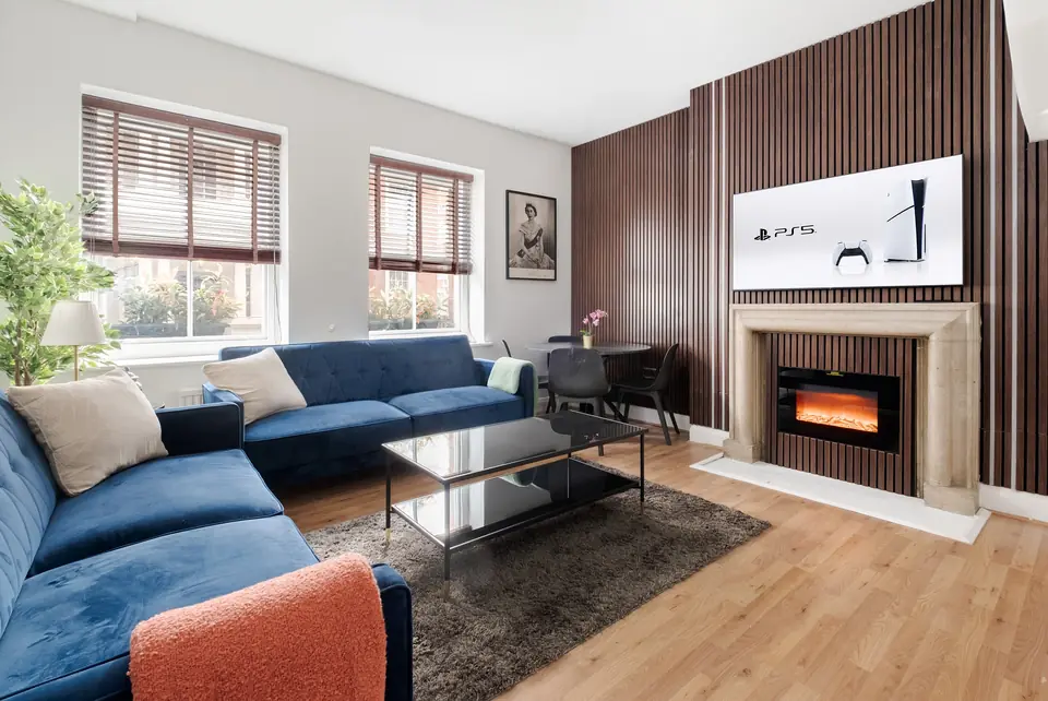 Living room with a fireplace and walnut panelling
